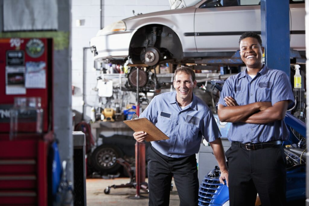 Two auto shop workers take inventory in a shop.