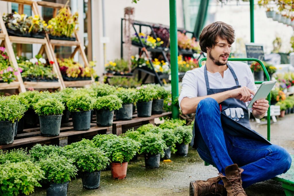 A landscaper reviews information on his tablet. 