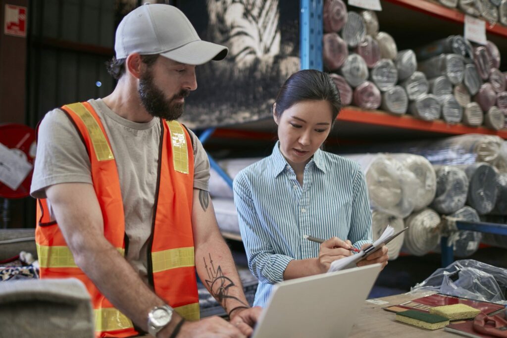 A warehouse manager and her employee take inventory together.